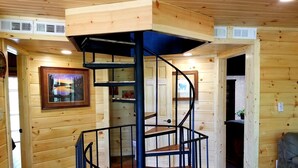 A spiral staircase with a wooden finish and metal railings, leading to an upper level. - Mountain View/2 King Suites/Hot Tub/Pool Table/Minutes to Ober & Downtown (Gatlinburg)