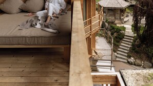A wooden cabin with a balcony overlooking a forested valley. - Naturhotel Lüsnerhof (Luson)