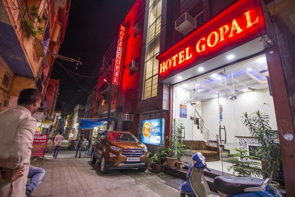 A hotel named 'Hotel Gopal' with a visible entrance and a parked car outside.