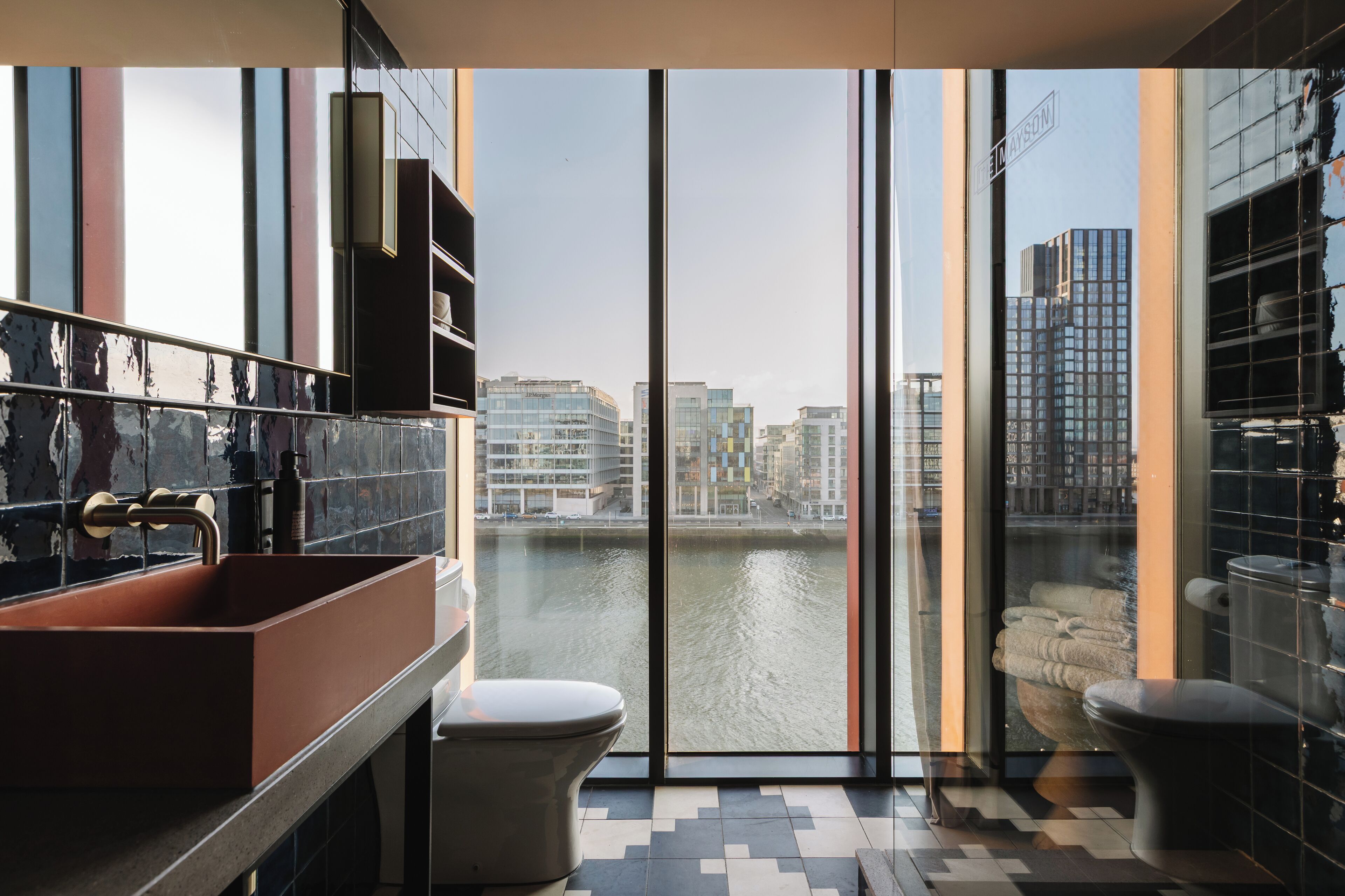 warehouse suite | bathroom | rainfall showerhead, designer toiletries, hair dryer, towels