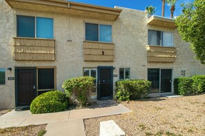A two-story building with a beige exterior, numbered 367, featuring a front door, two windows, and a small front yard with bushes. - Updated Condo in A+ Old Town Scottsdale Location! (Scottsdale)