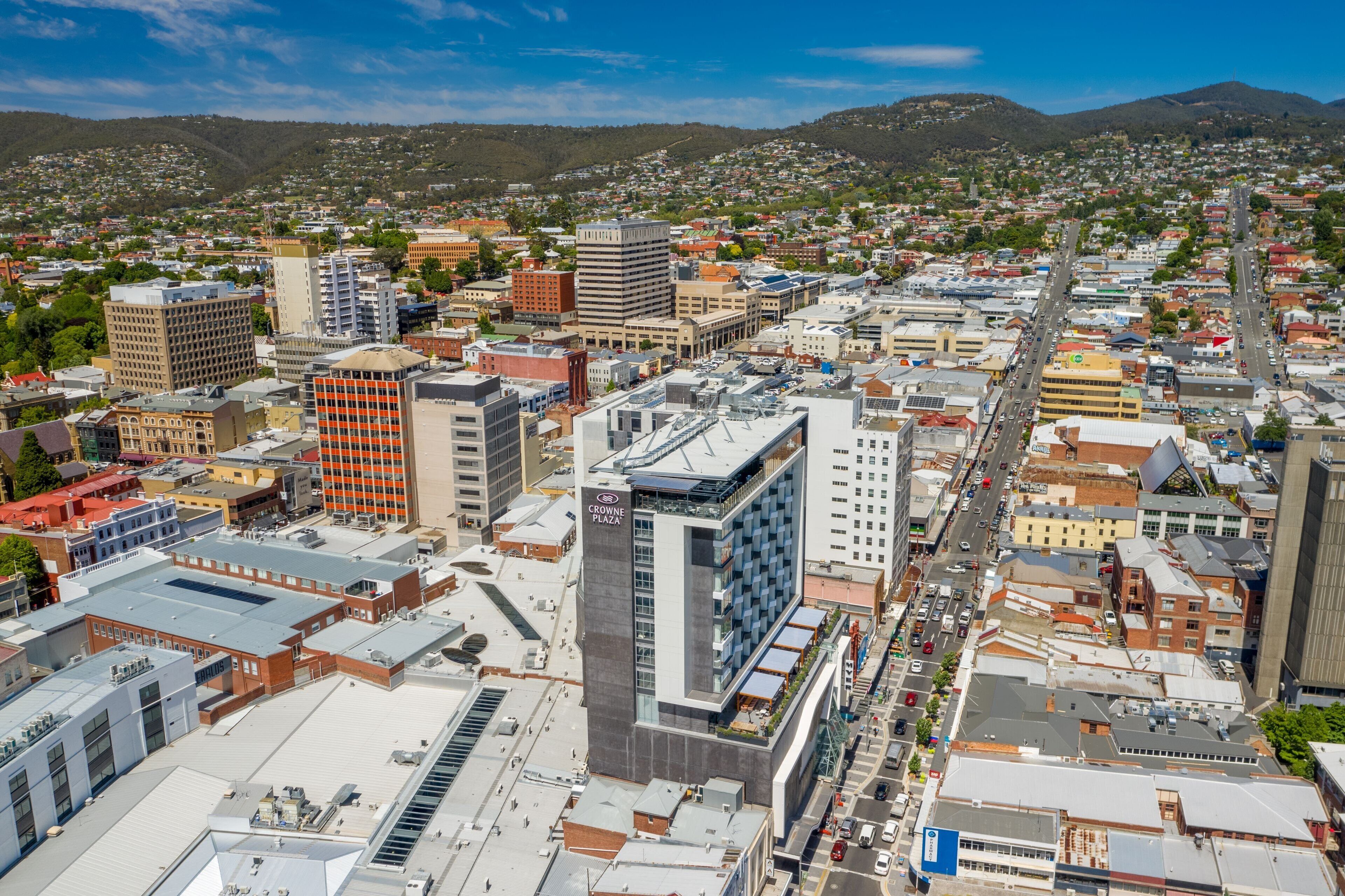 A cityscape with a prominent building labeled "Crowne Plaza."