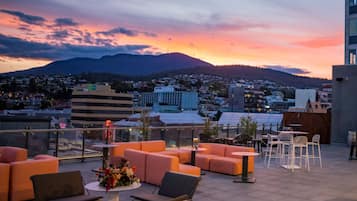 Relax on the outdoor terrace with comfortable seating and scenic city views.
