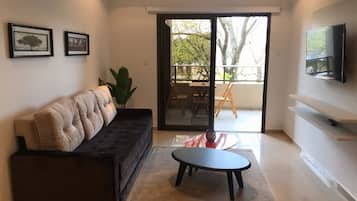 Appartement Deluxe | Coin séjour | Télévision à écran plat, Netflix, services de streaming