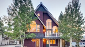 A two-story house with a balcony, large windows, and a front porch. - Breck Town Lodge | In Town | Walkability (Breckenridge)
