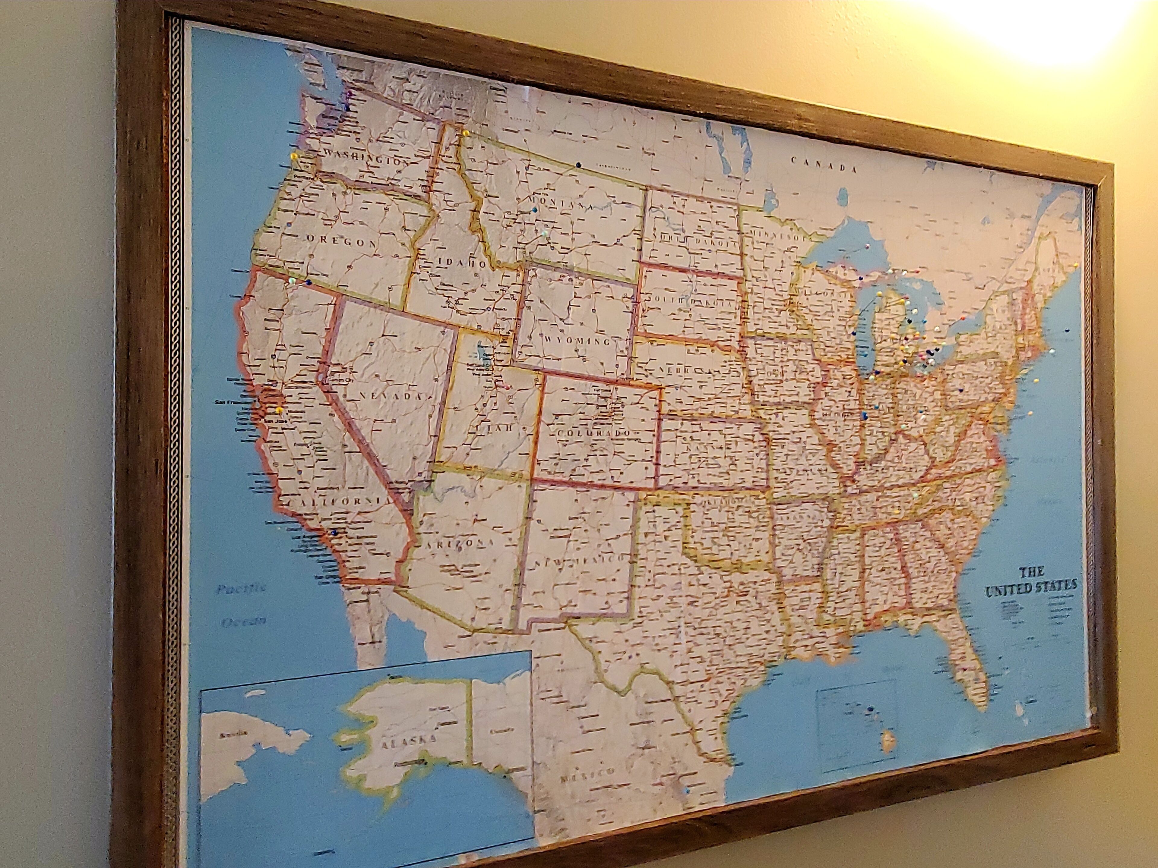 A framed map of the United States with state boundaries and major cities labeled.