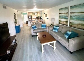 A living room with a sofa, coffee table, and a TV. - 🦩 Charming 2BR Condo Pool View ~ Siesta Key Bay Oaks🦩 (Sarasota)