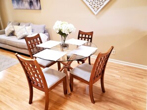 Enjoy meals in this inviting dining area with a round table and comfortable seating for four.