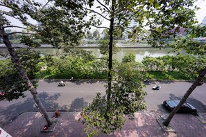 A view of a river with trees and a road. - Pepper House Studio Apartment (Ho Chi Minh City)