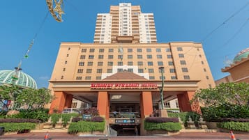 Enter the Sunway Pyramid Hotel through its prominent entrance, offering a clear view of the parking area.