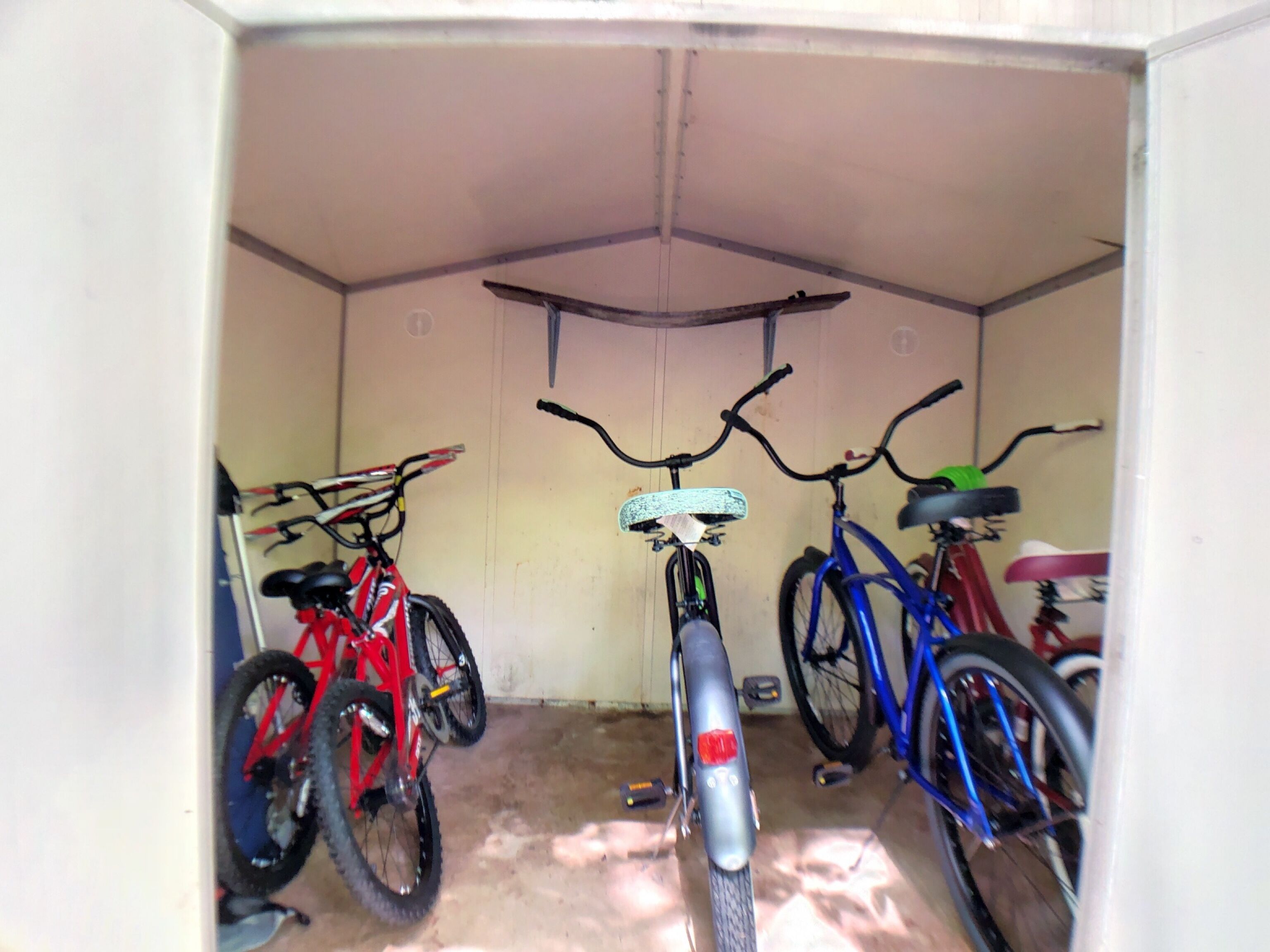 A garage with three bicycles parked inside.