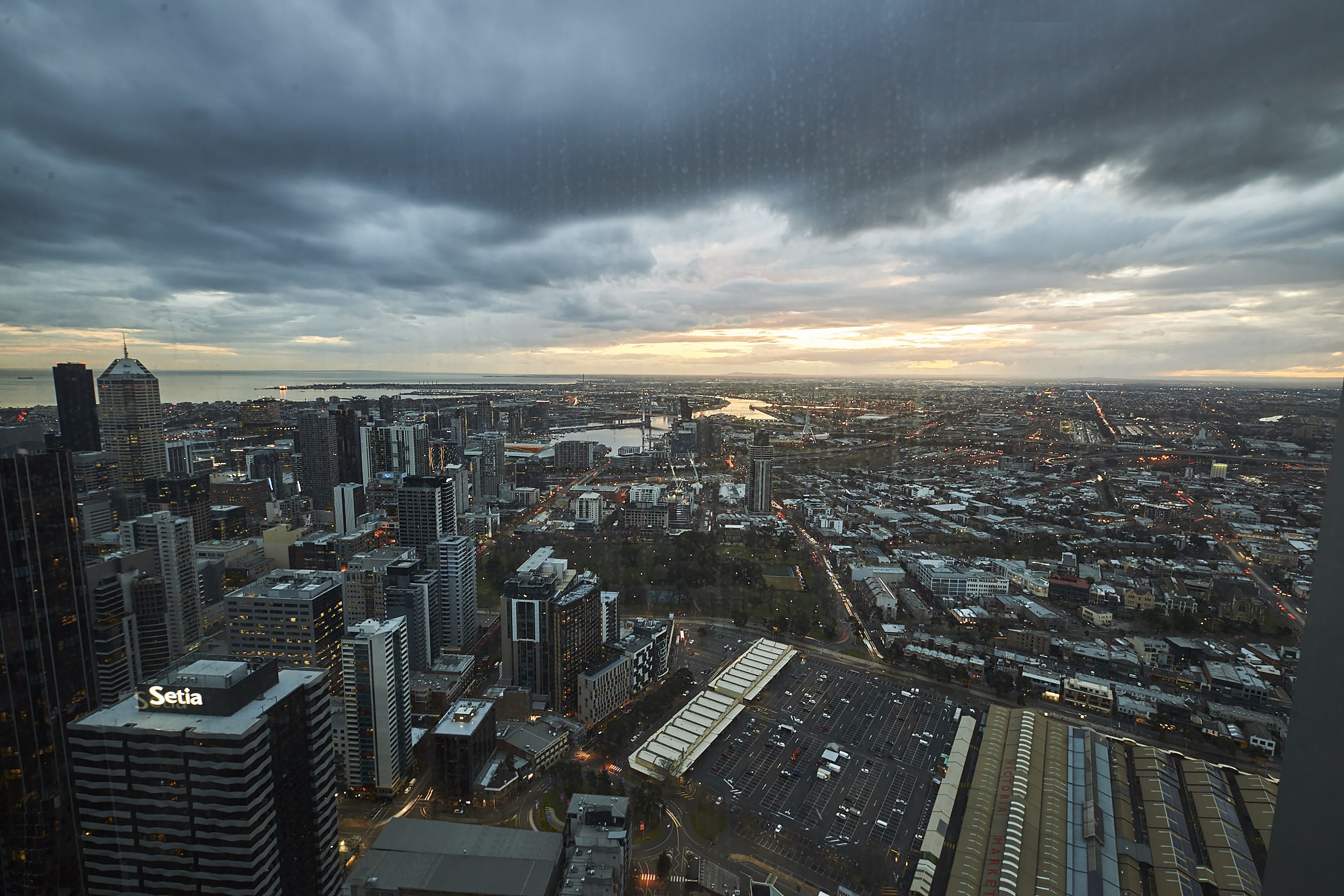 A cityscape with high-rise buildings, including a prominent 'Setia' sign, and a large parking area.