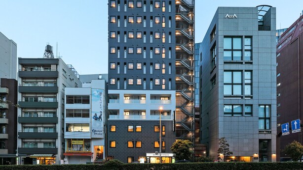 A modern hotel building with multiple floors, a prominent sign for LIVEMAX HOTEL & RESORTS, and a visible entrance. - Hotel Livemax Shinjuku East (Tokyo)