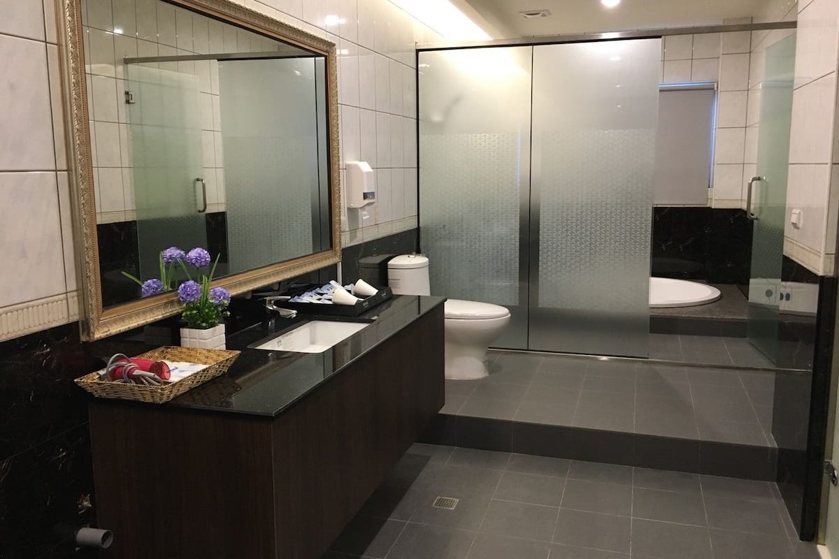 deluxe quadruple room | bathroom | shower, free toiletries, hair dryer, slippers