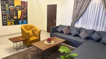 Family Apartment, 3 Bedrooms | Living area | Flat-screen TV