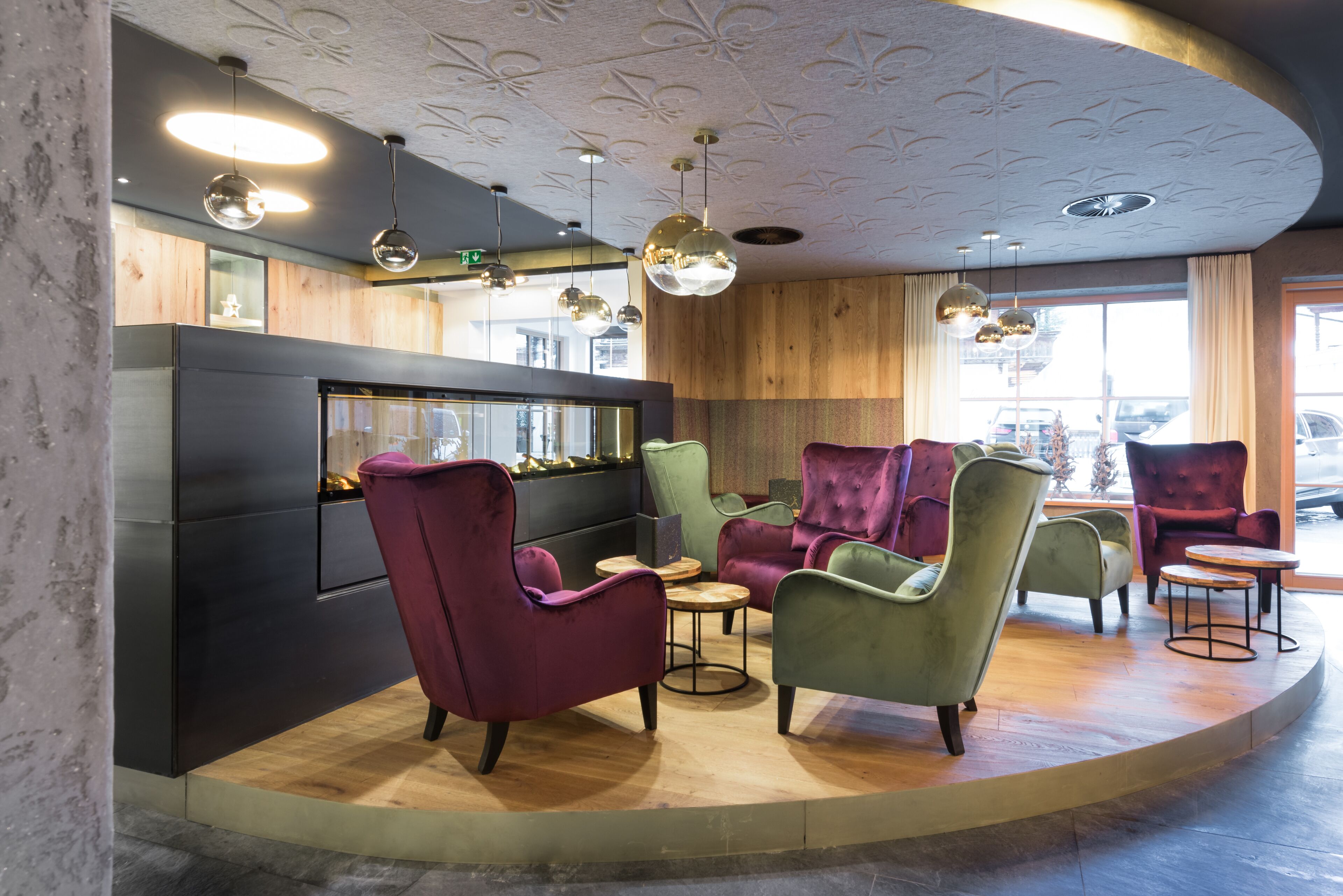 A modern interior with a curved seating area, a bar counter, and pendant lighting.