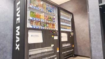 Two vending machines labeled 'LIVEMAX' in a hotel setting.