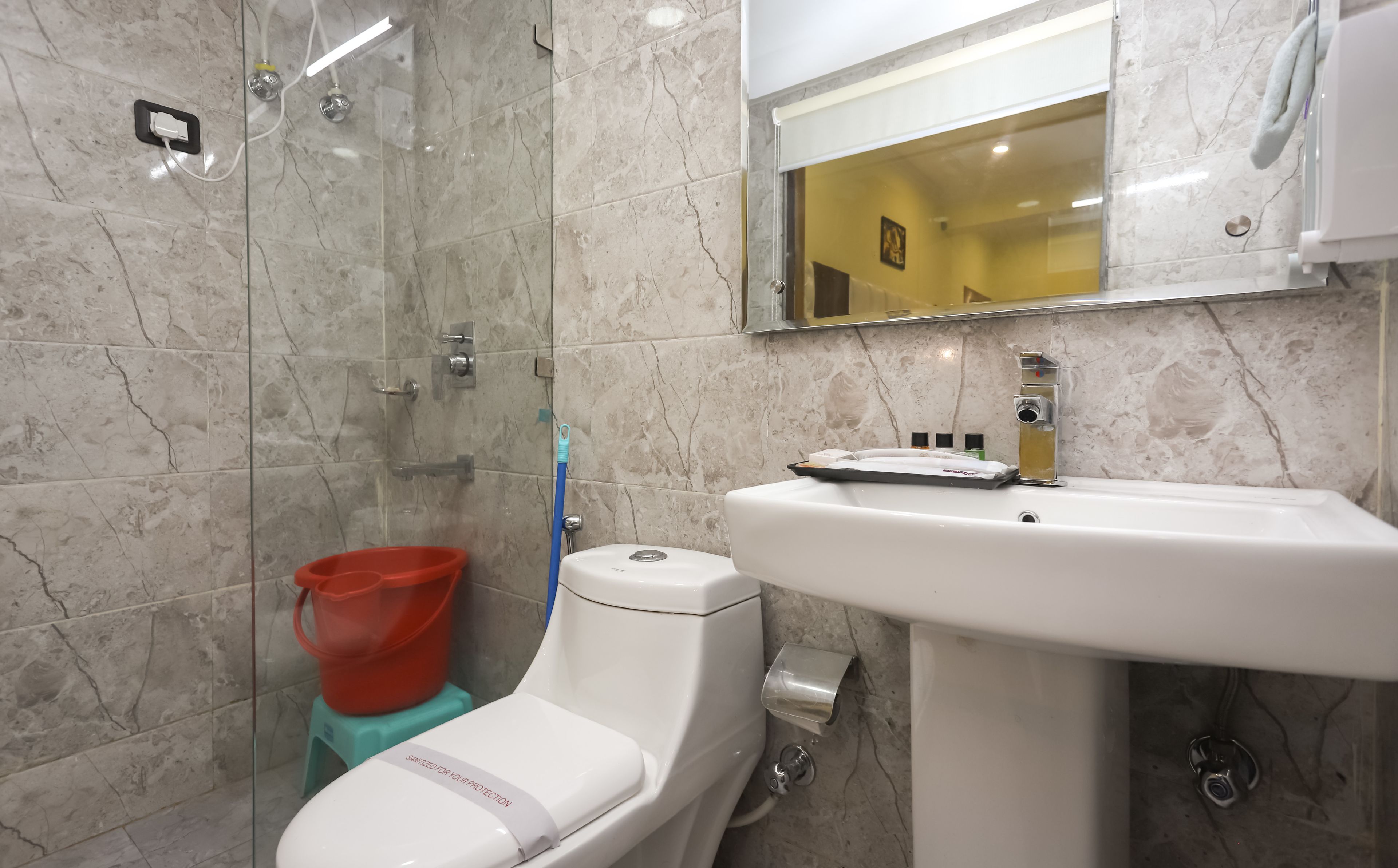 A bathroom with a shower, toilet, and sink.