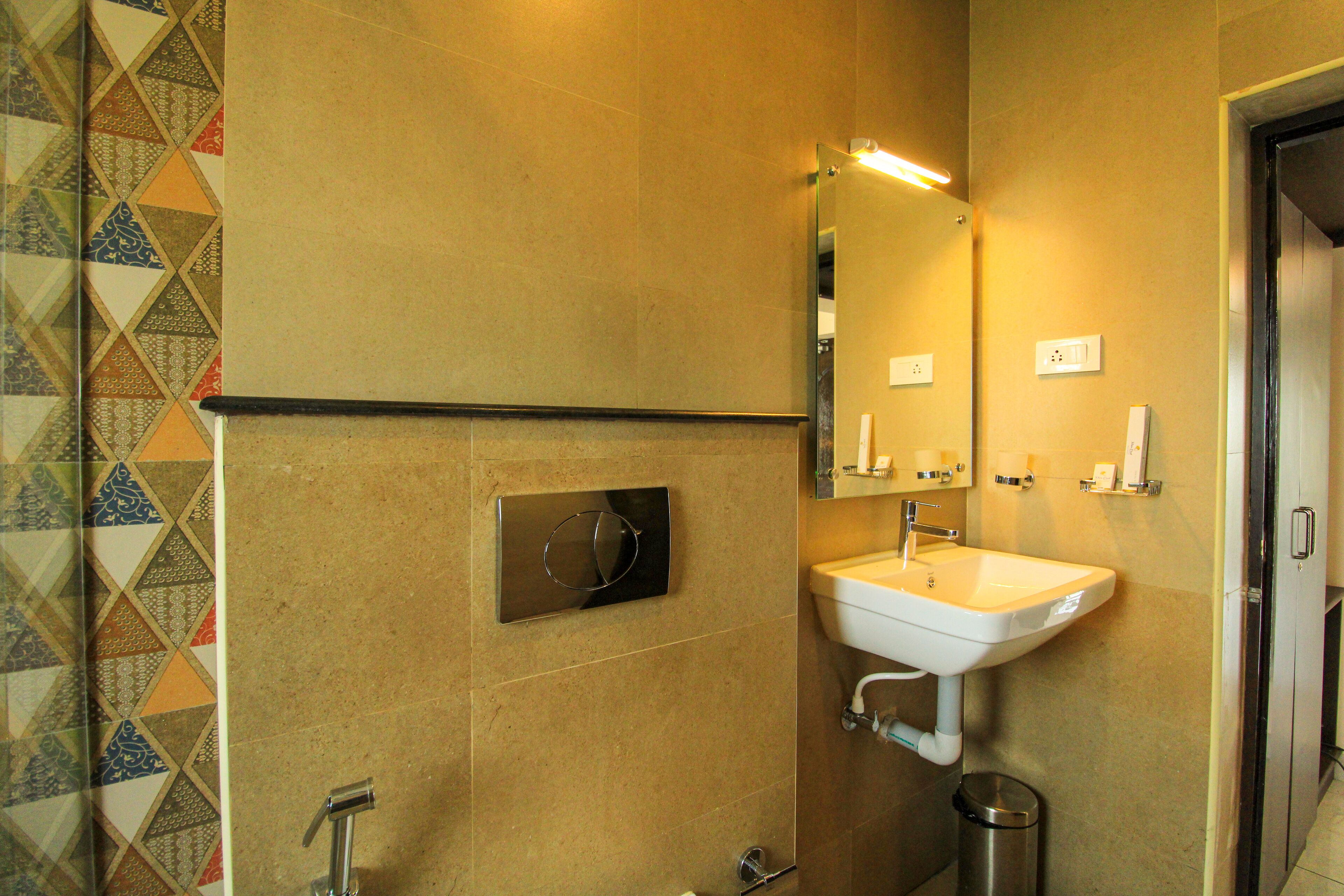 A bathroom with a sink, mirror, and towel rack.