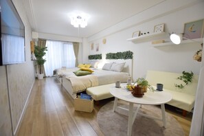 A modern, well-lit bedroom with a bed, bedside table, and a small seating area. - Nipponbashi Art Hotel (Osaka)