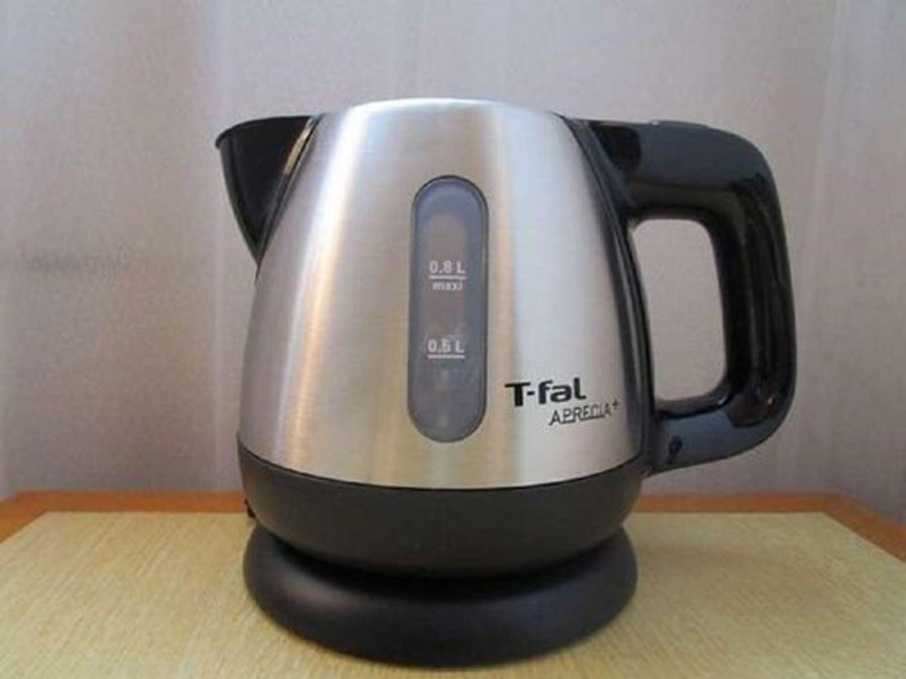 A T-fal electric kettle with a digital display, placed on a table.