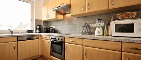 Apartamento | Cozinha privada | Geladeira, fogão, cooktop, lava-louças