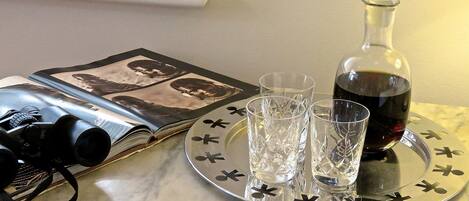 A table with a book, a bottle of wine, and two glasses.