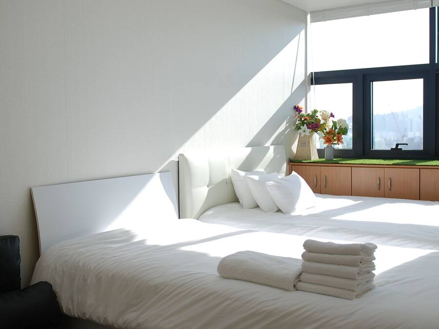 Premium bedding, desk, laptop workspace, iron/ironing board