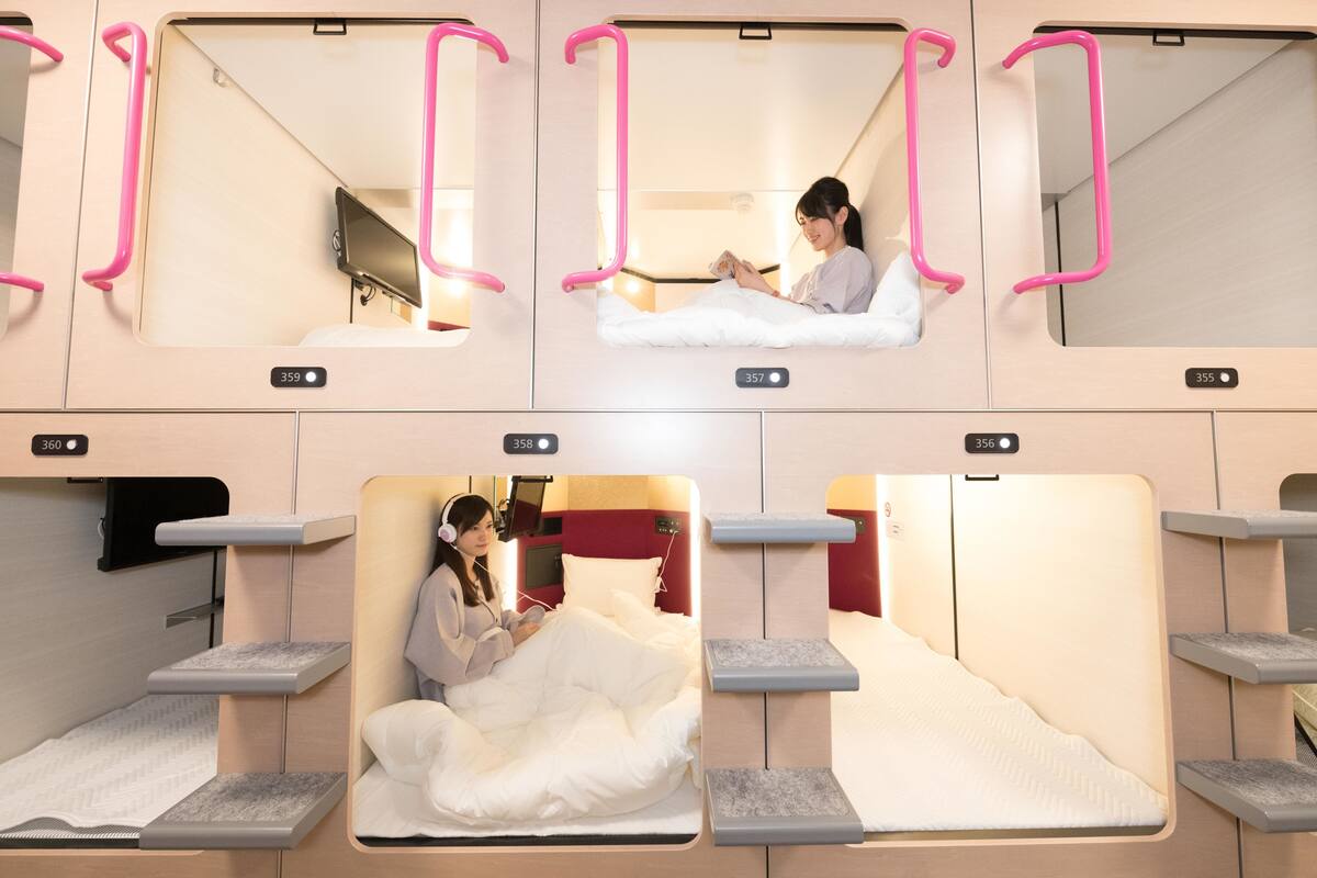 A series of private rooms with individual beds, each with a small bedside table and a personal TV.