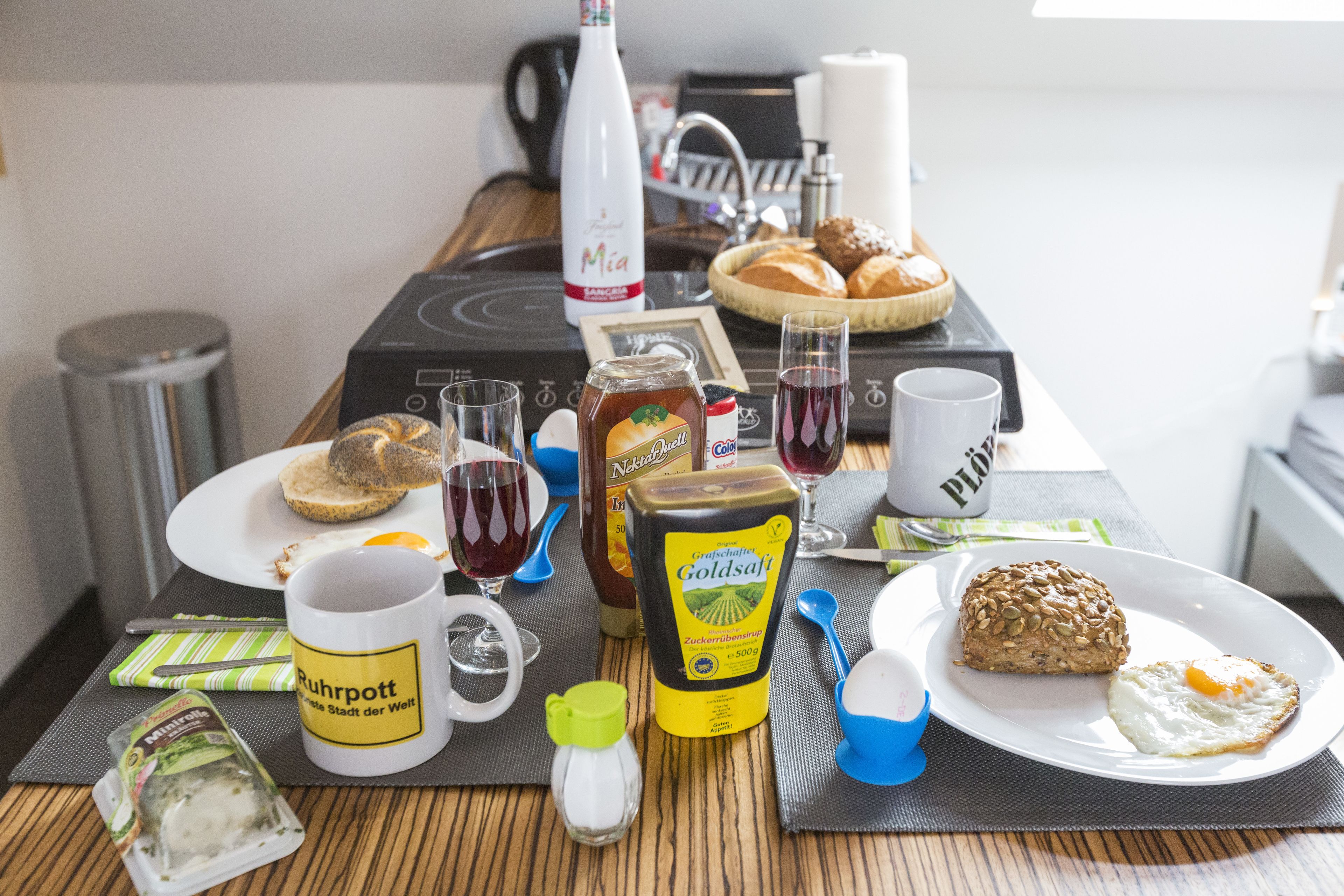 Une table de petit-déjeuner avec divers aliments, boissons et condiments.