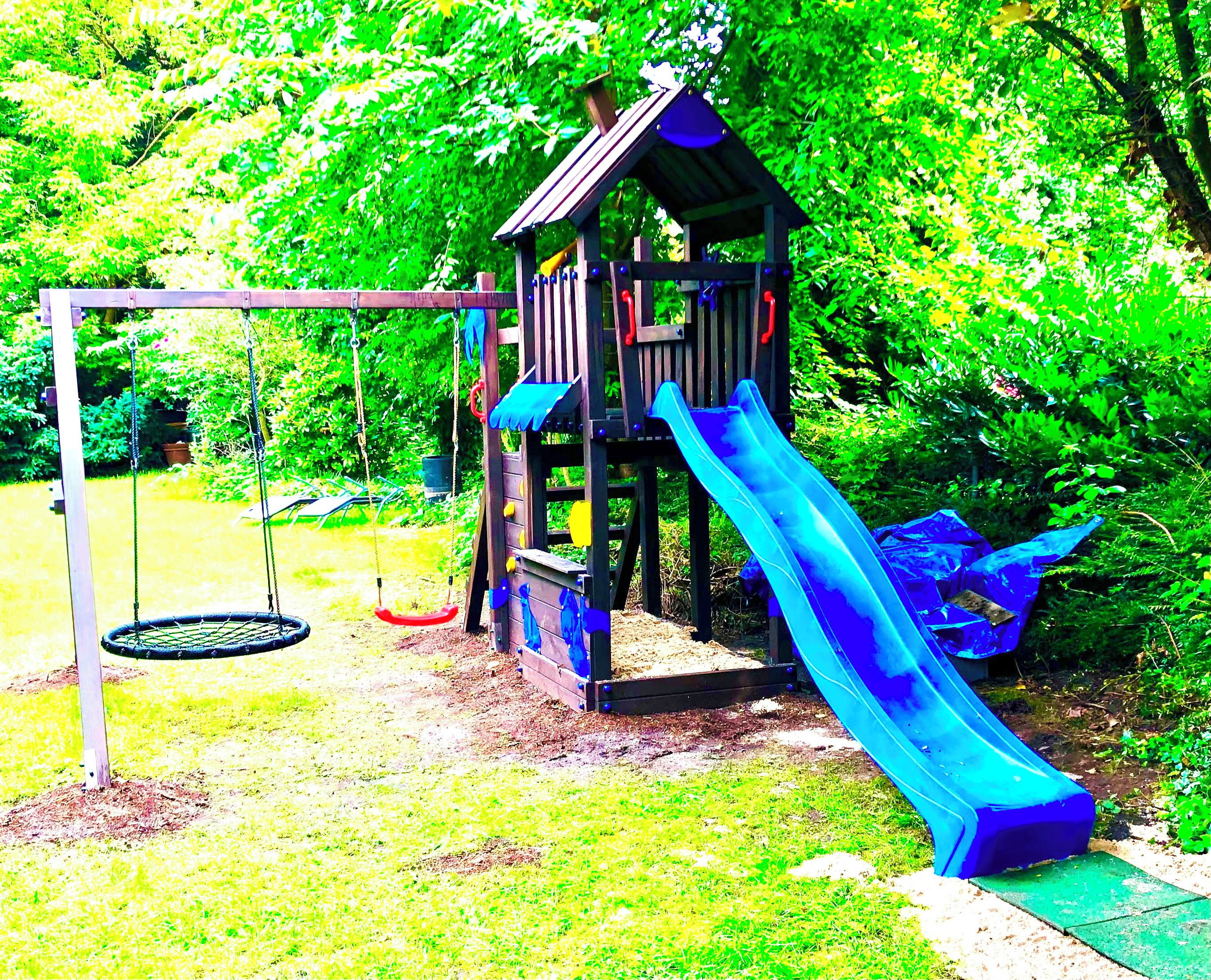 A playground with a slide and swings.