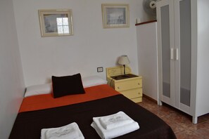 Desk, laptop workspace, blackout drapes, iron/ironing board