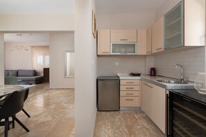 A modern kitchen with a built-in oven, a microwave, and a sink.