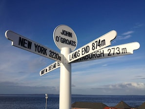A directional signpost with multiple arms pointing to various destinations.