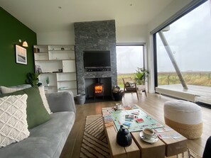 Relax in this cozy living space with a fireplace, flat-screen TV, and comfortable seating area.