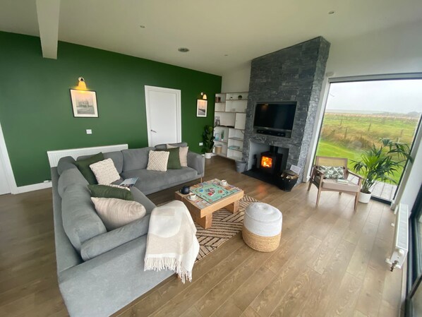 Relax in this inviting living room with a comfortable sofa, coffee table, and stone fireplace.