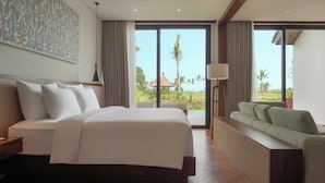 A hotel room with a large bed, a sofa, a ceiling with a woven pattern, and a view of palm trees and a building outside. - The Garcia Ubud Hotel & Resort (Ubud)