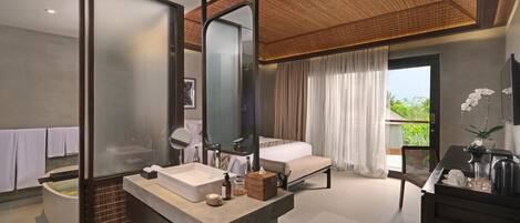 A modern bathroom with a large mirror, a bathtub, and a vanity with a sink.