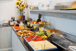 A buffet with various food items including fruits, vegetables, and pastries. - Residenza Turistica Alberghiera Blue Marine (San Michele al Tagliamento)