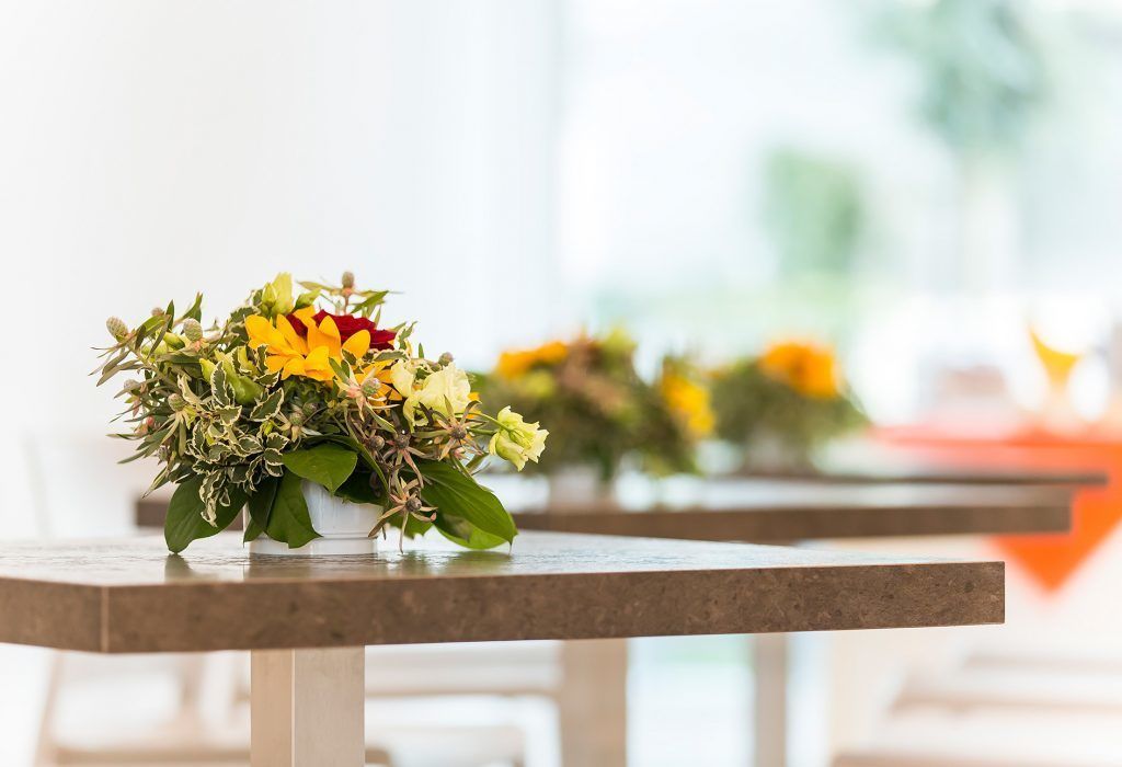 A table with a floral arrangement.