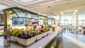 A buffet area with various fruits and a modern interior design. - Royal Palm Resort & Spa - Adults Only (Pajara)