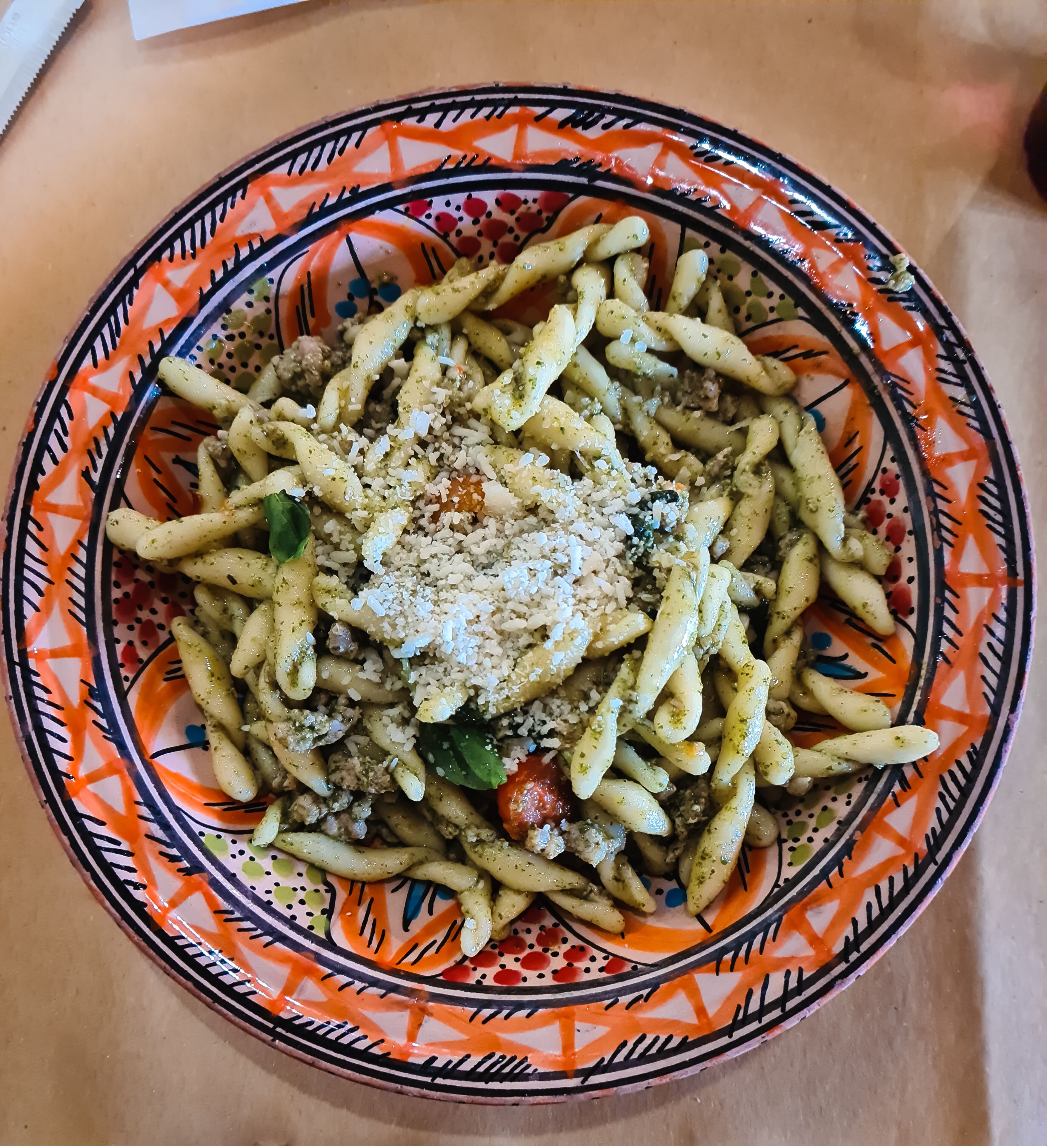 A plate of pasta with a colorful pattern around the rim.