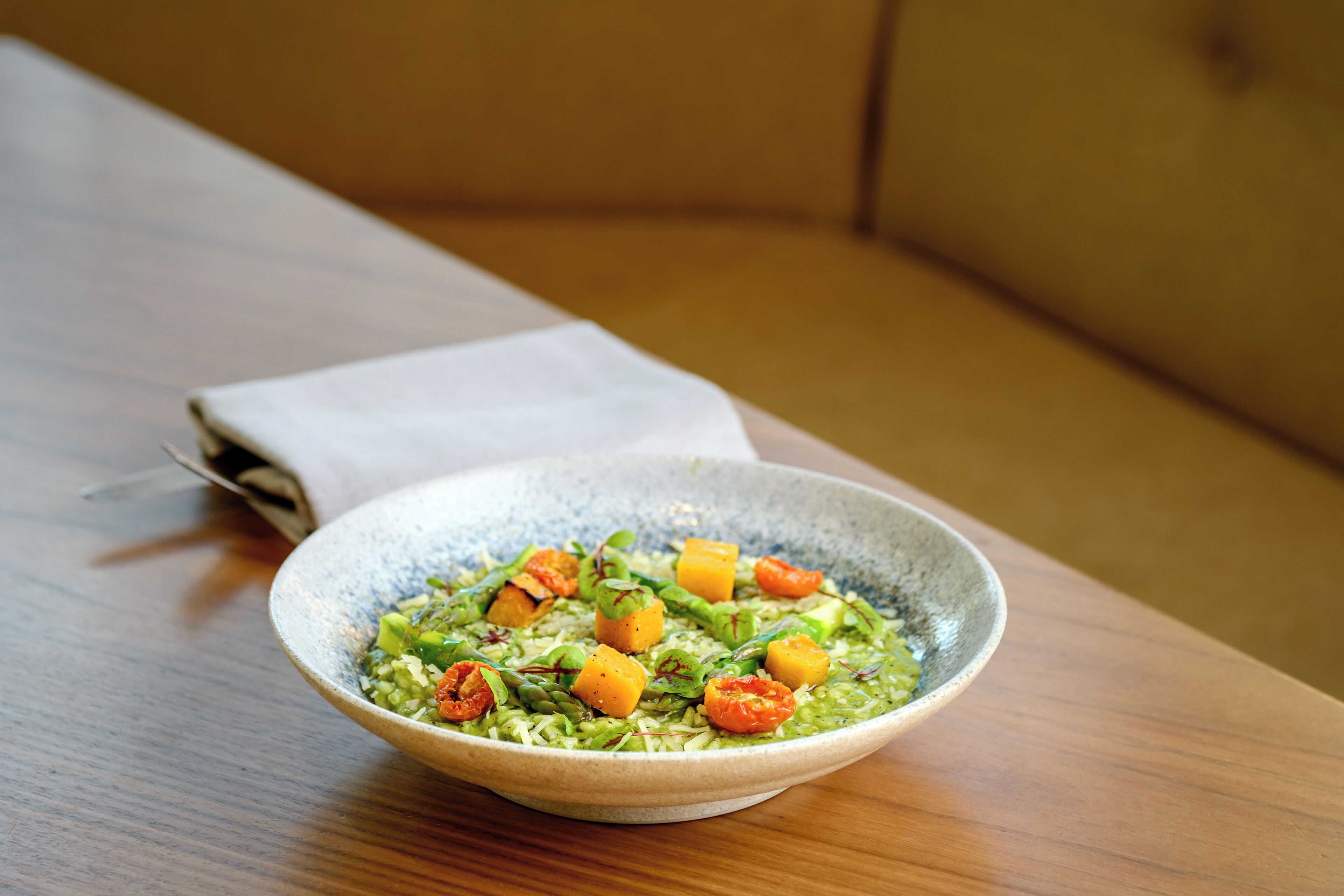 A bowl of food on a wooden table.