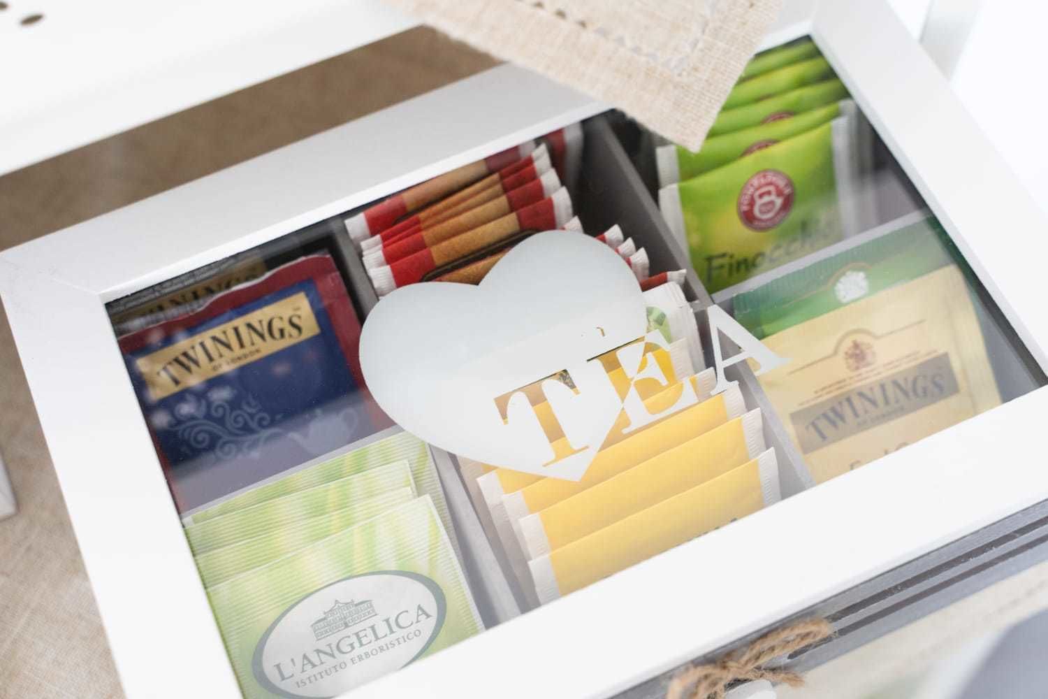 A drawer containing various items including a heart-shaped object with the letters "TIA" and several packs of cigarettes.