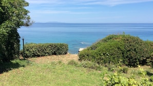 A garden with a view of the sea, a paved area, and a potted plant. - Villa on the sea in Punta Tramontana with an exclusive view of the Gulf of Asinara (Punta Tramontana (Castelsardo))