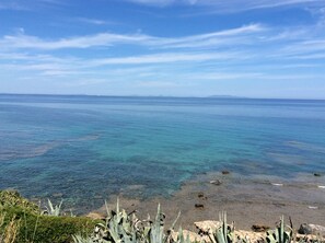 Enjoy breathtaking views of the ocean and distant shoreline from this serene beach setting.