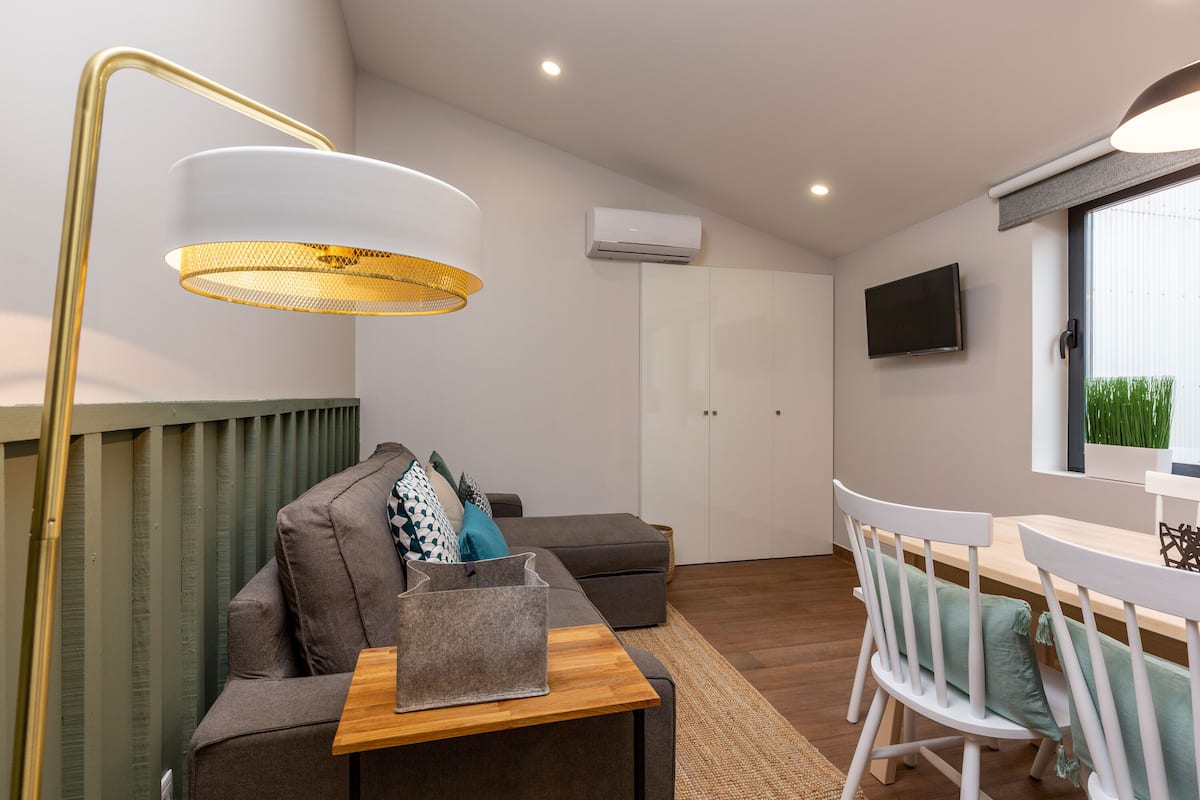 Apartment, 1 Bedroom (Wine V) | Living area | Flat-screen TV