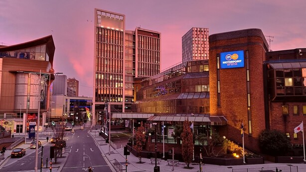 A modern building with a sign for MOTORPOINT arena, a street with cars, and a clear sky. - The Hazeldene Apartment (Cardiff)