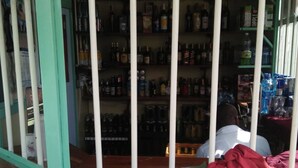 A liquor store with shelves stocked with various bottles. - Mt Kenya Safari Halt Hotel (Chaka)