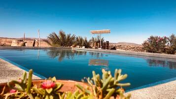 Outdoor pool, an infinity pool, pool loungers